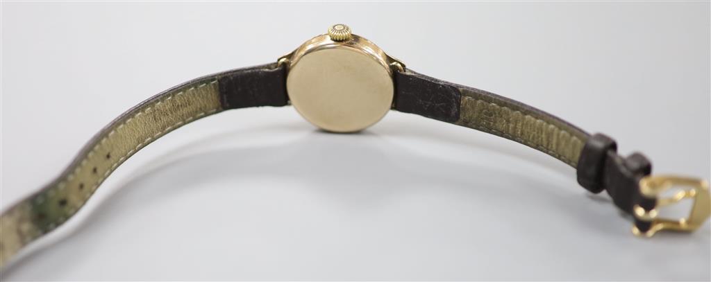 A ladys 1920s 9ct gold Rolex manual wind wrist watch, on associated leather strap, case diameter 25mm ex. crown, gross 18.2 grams.